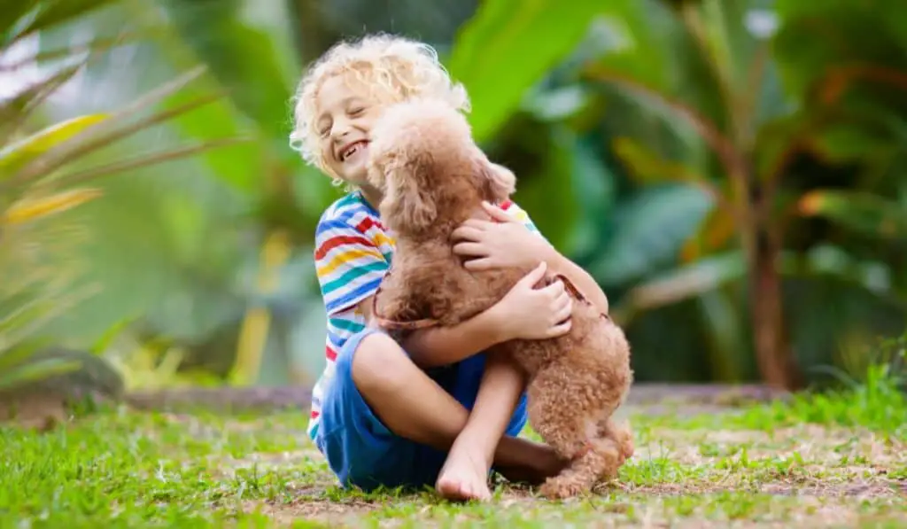 Kid hugging dog